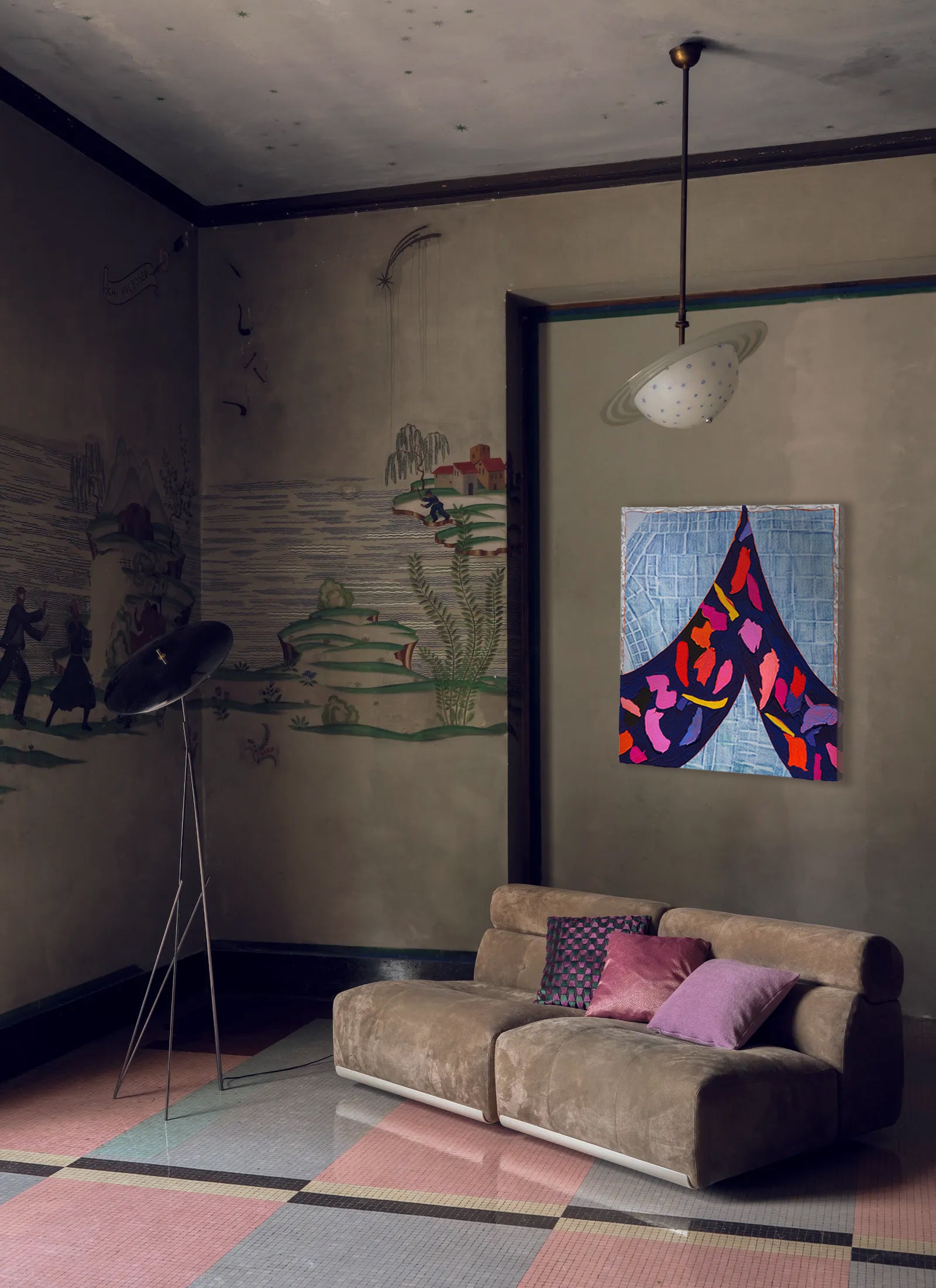 Living room with a sofa, colorful abstract painting, and decorative wall art.