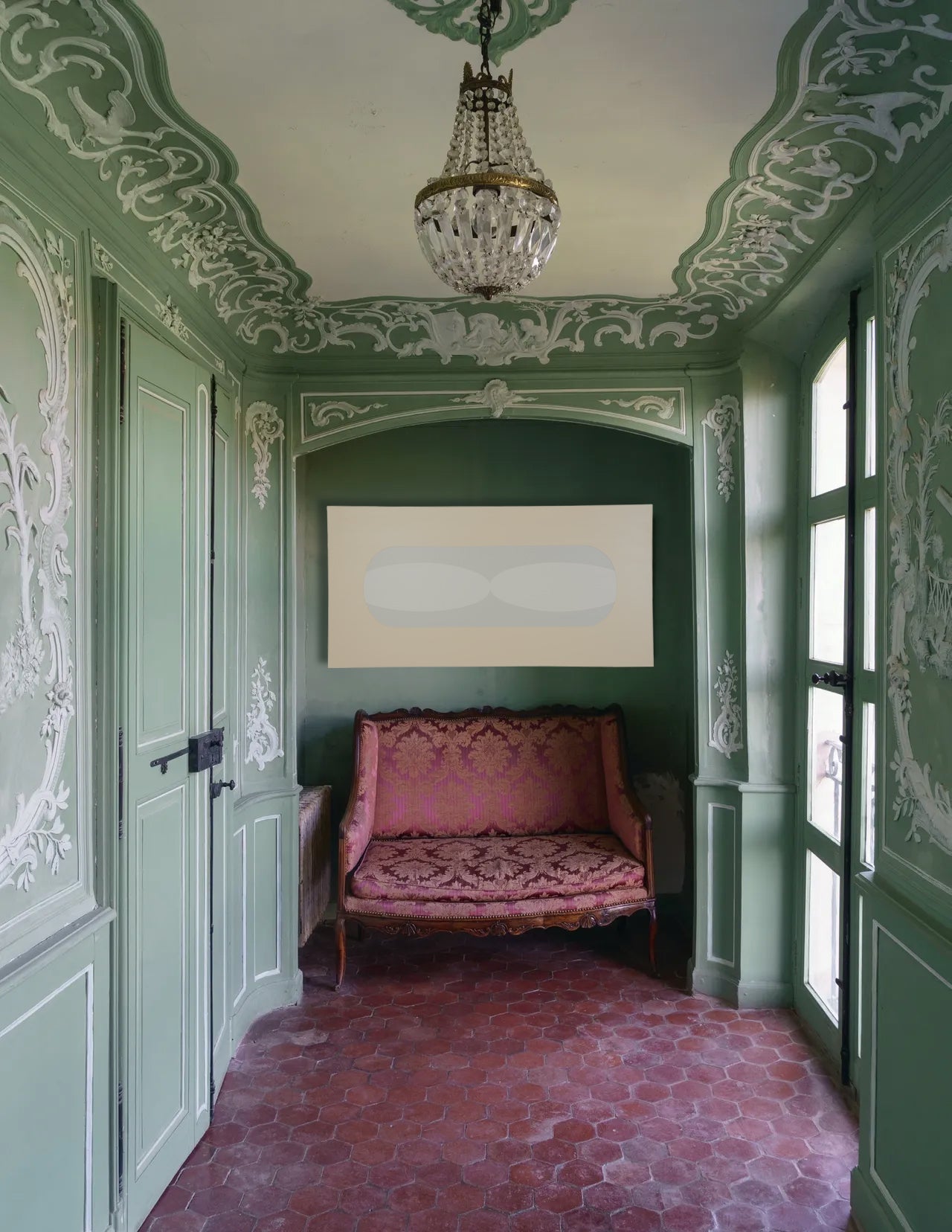 Decorative interior with ornate ceiling, pink floral sofa, and modern abstract artwork.