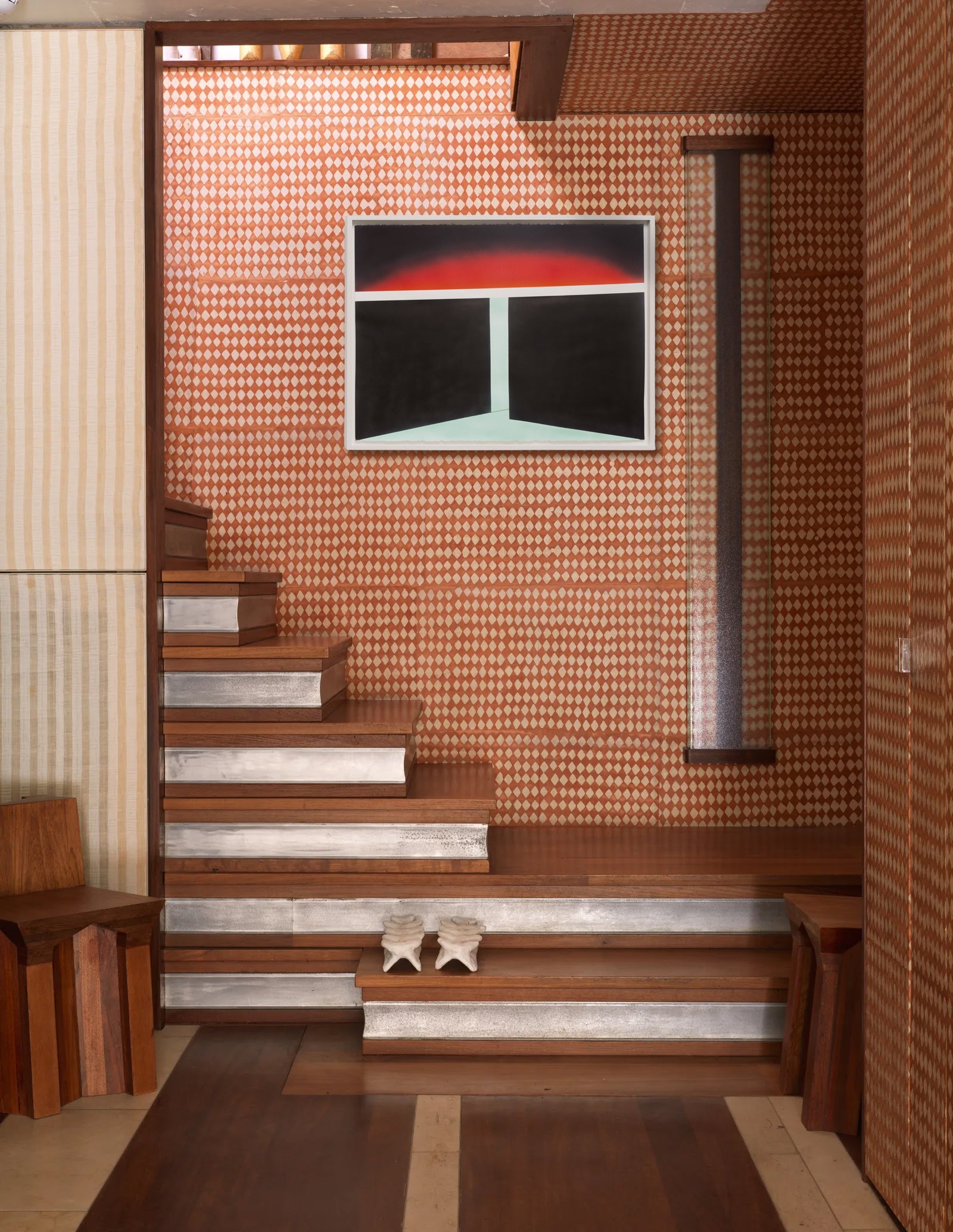 Staircase with wooden steps and a wall with a modern abstract painting.