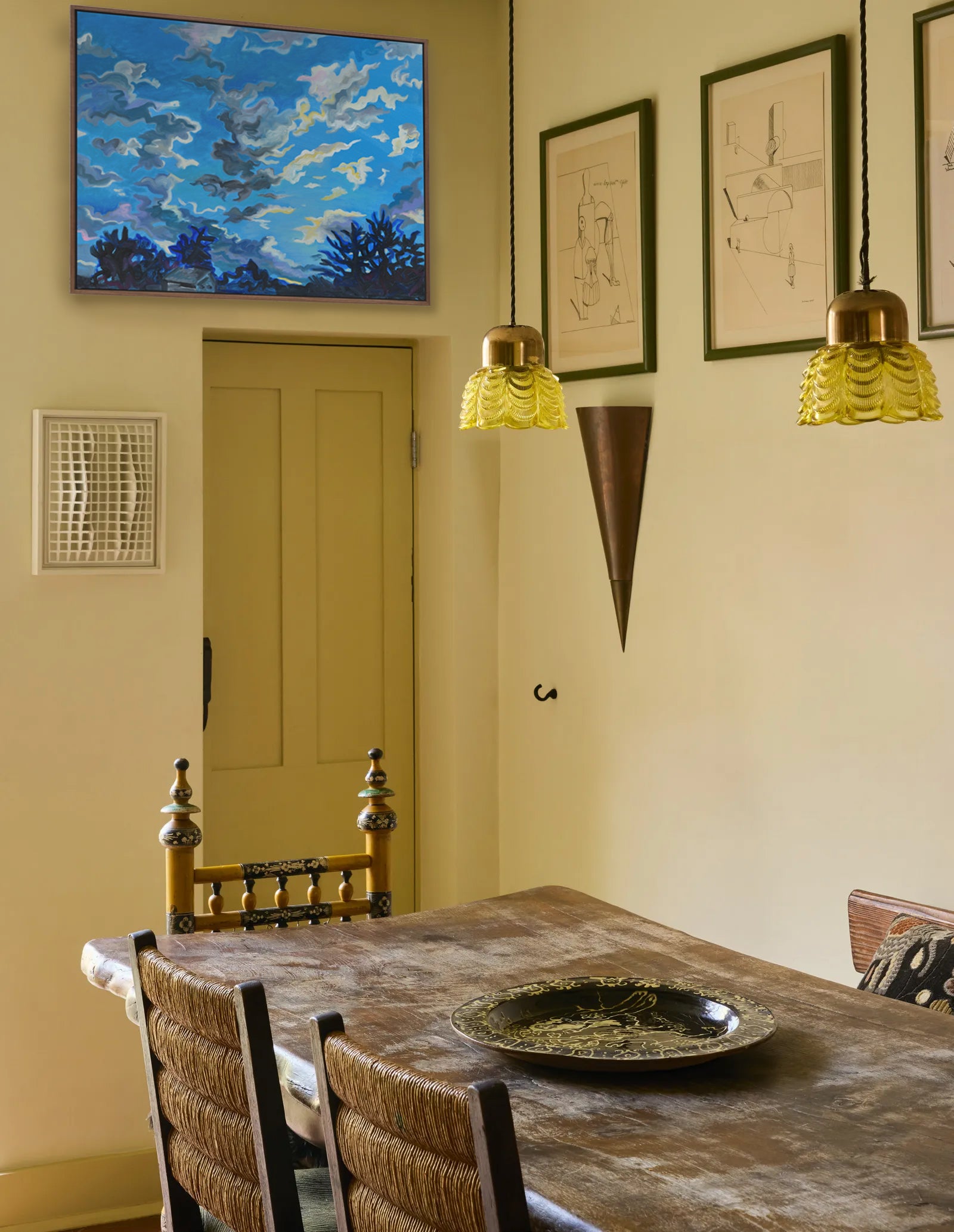 Dining room with a table, chairs, and wall art in a home setting.