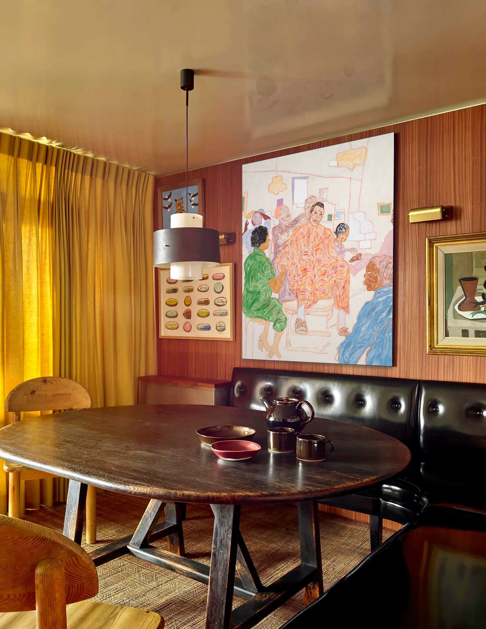 Dining room with wooden table, leather bench, and wall art