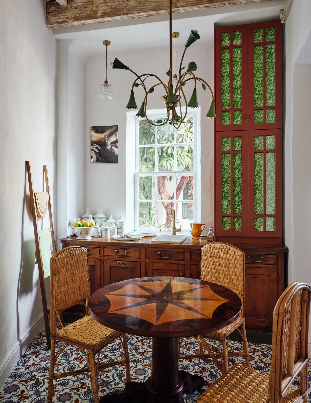Dining room with wooden table, chairs, and a chandelier.