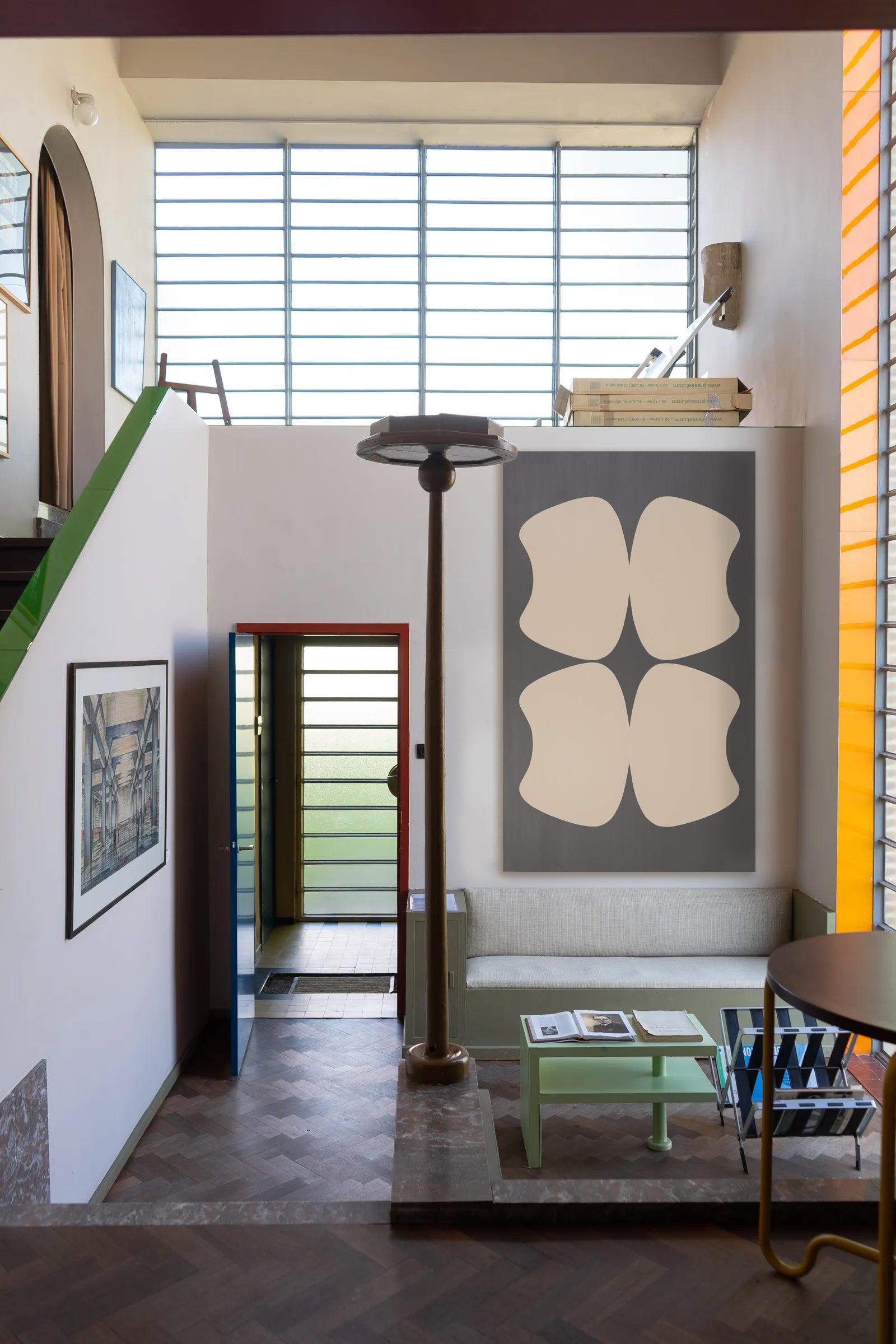 Modern interior with abstract art, a lamp, and a bench.
