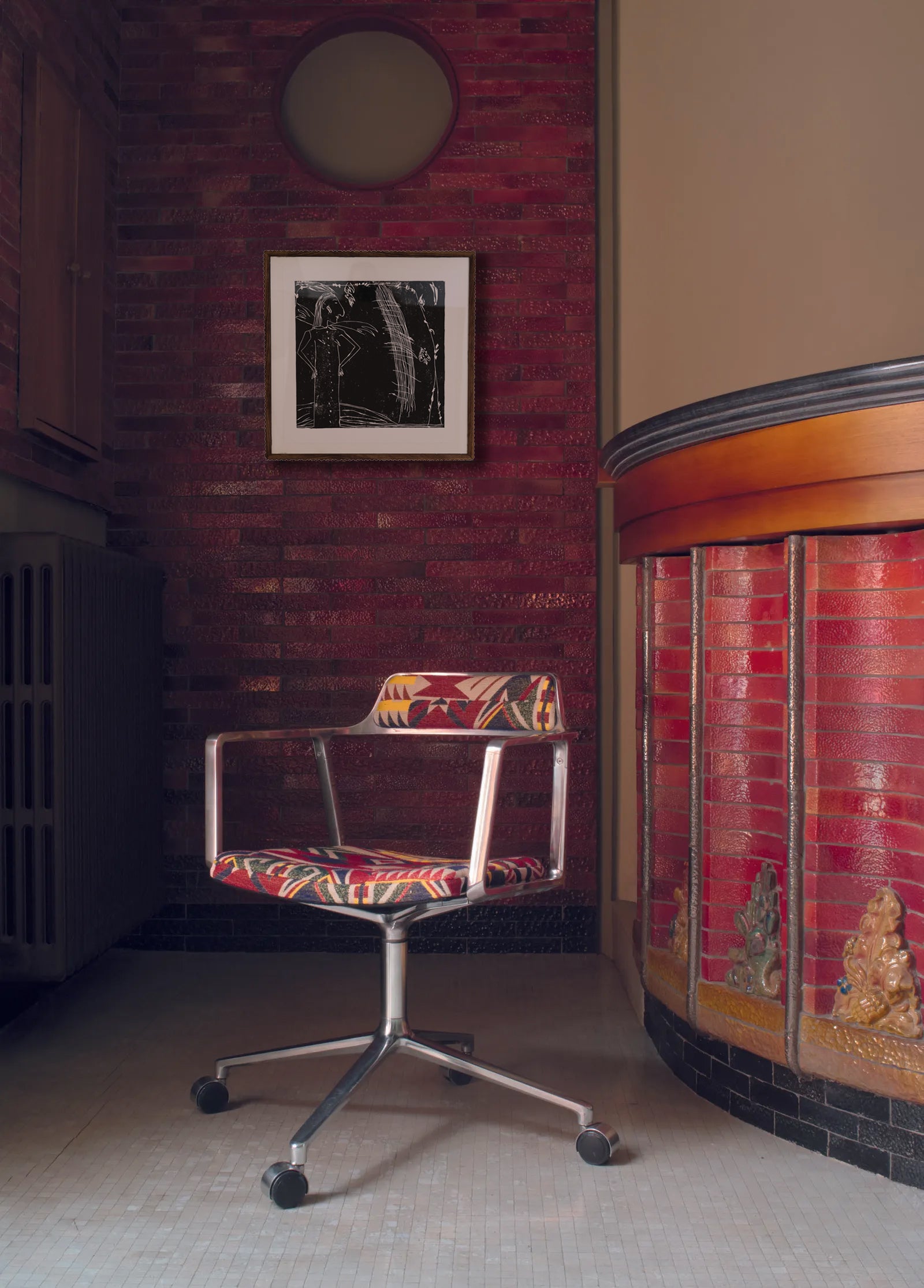 Colorful office chair in a room with a brick wall and decorative elements.